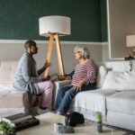Doctor measuring a senior woman's blood pressure in the bedroom