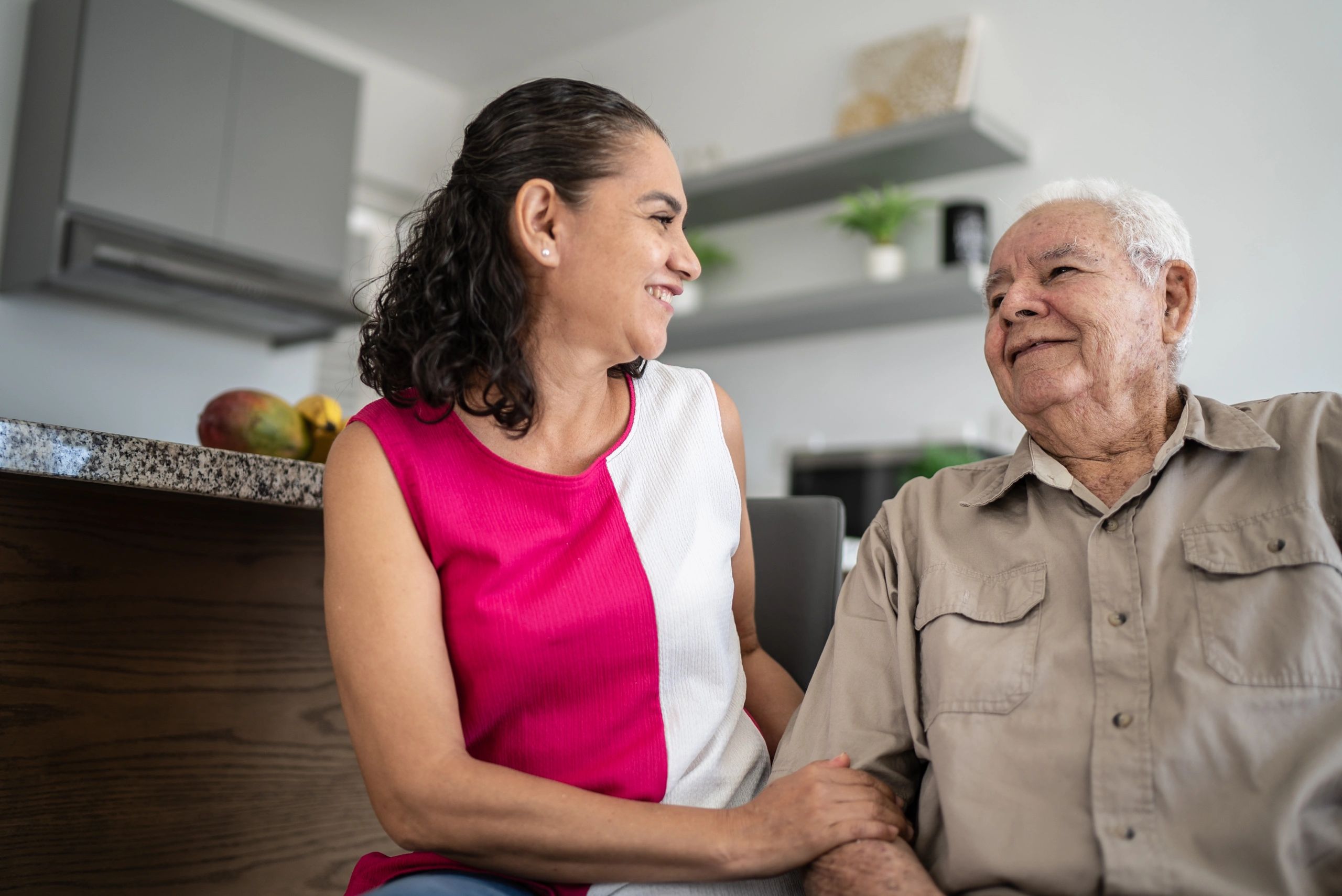 Senior man talking with caregiver at home