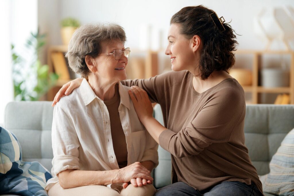 Happy senior woman with caregiver at home